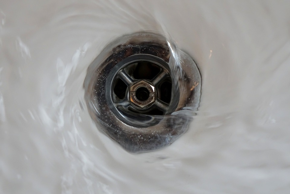 Water spiraling down a drain
