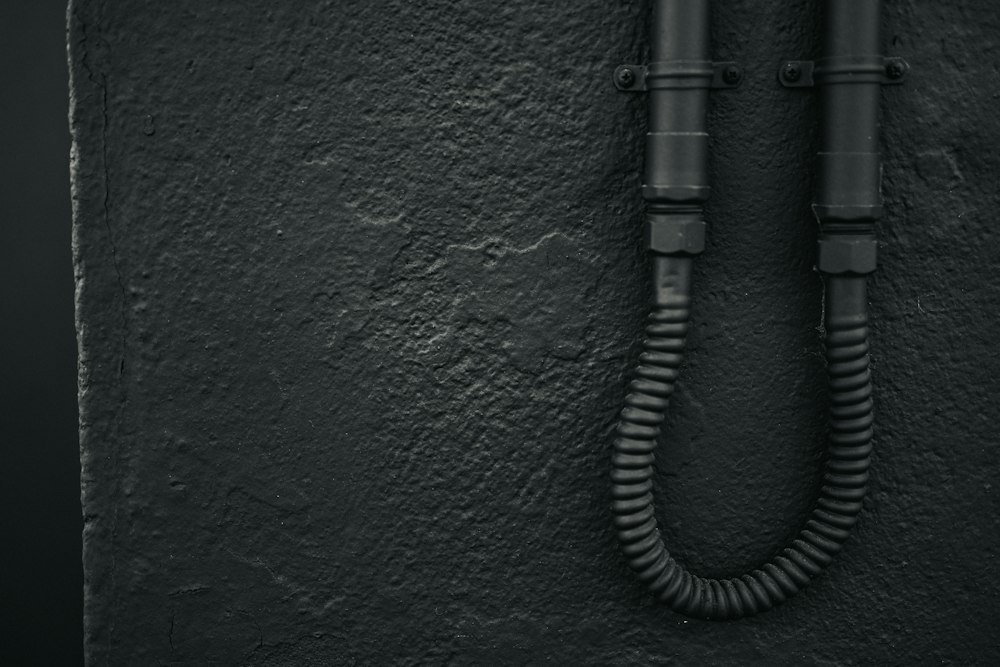 Black color pipe on a wall