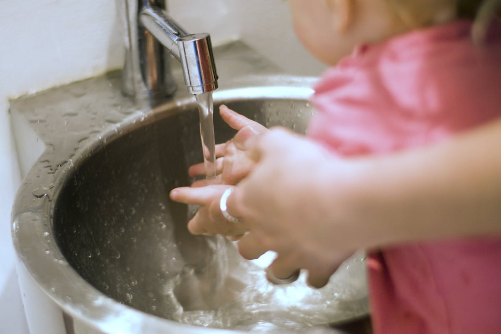 An image of a person and child washing their hands Image caption: clean water for use
