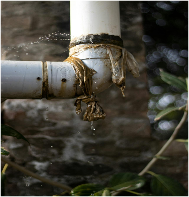Temporary plastic fix on leaking pipe caused by poor plumbing installation during a bathroom renovation.