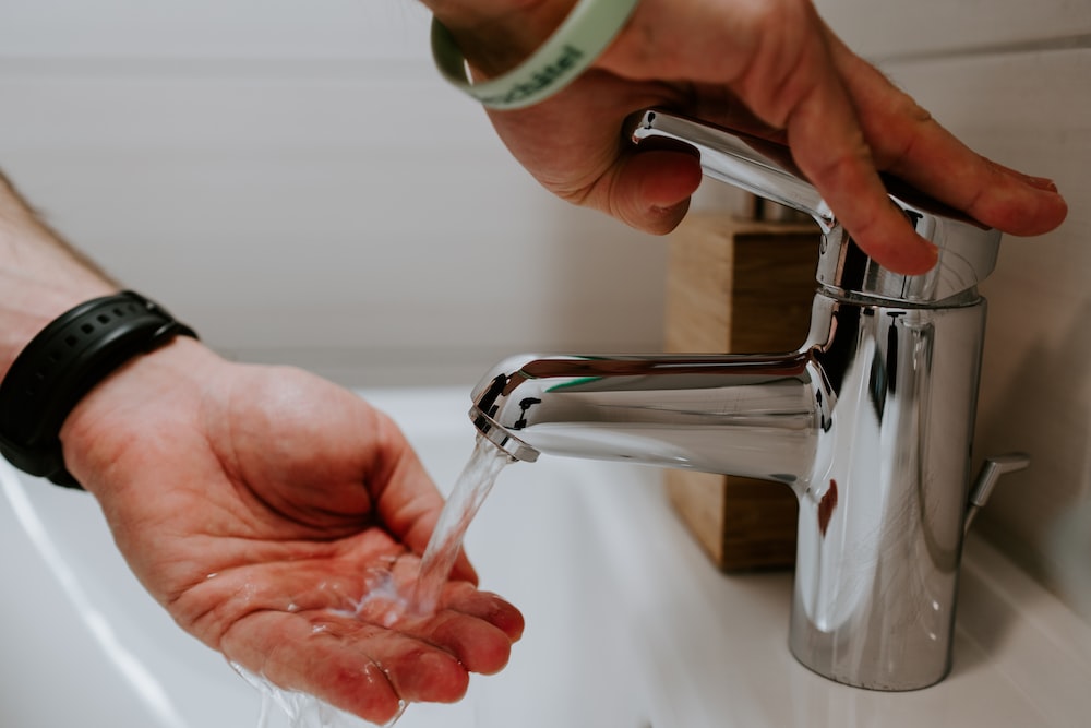 A person washing their hand
